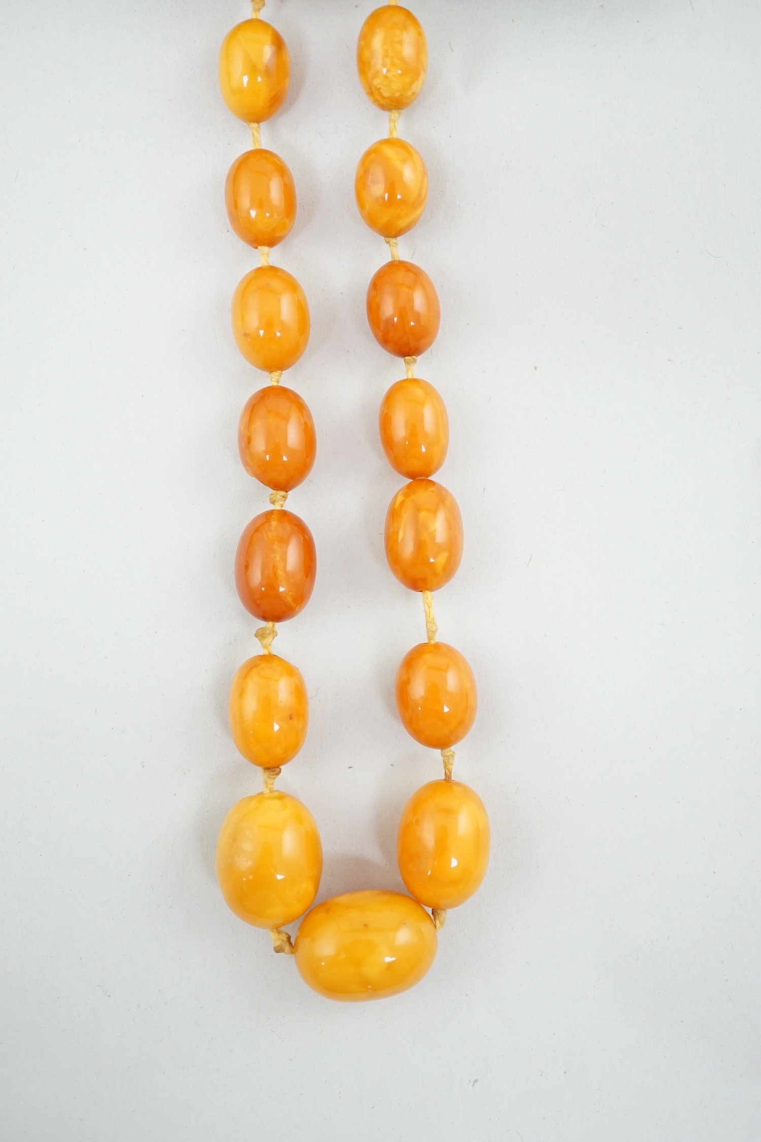 A single strand graduated oval amber bead necklace